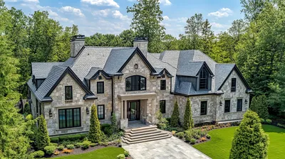 Grand custom home exterior with stone and landscaping