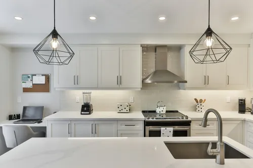 Beautifully remodeled modern kitchen with white cabinets and marble countertops